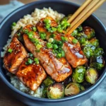 Healthy and colorful teriyaki salmon bowls with golden crispy Brussels sprouts.